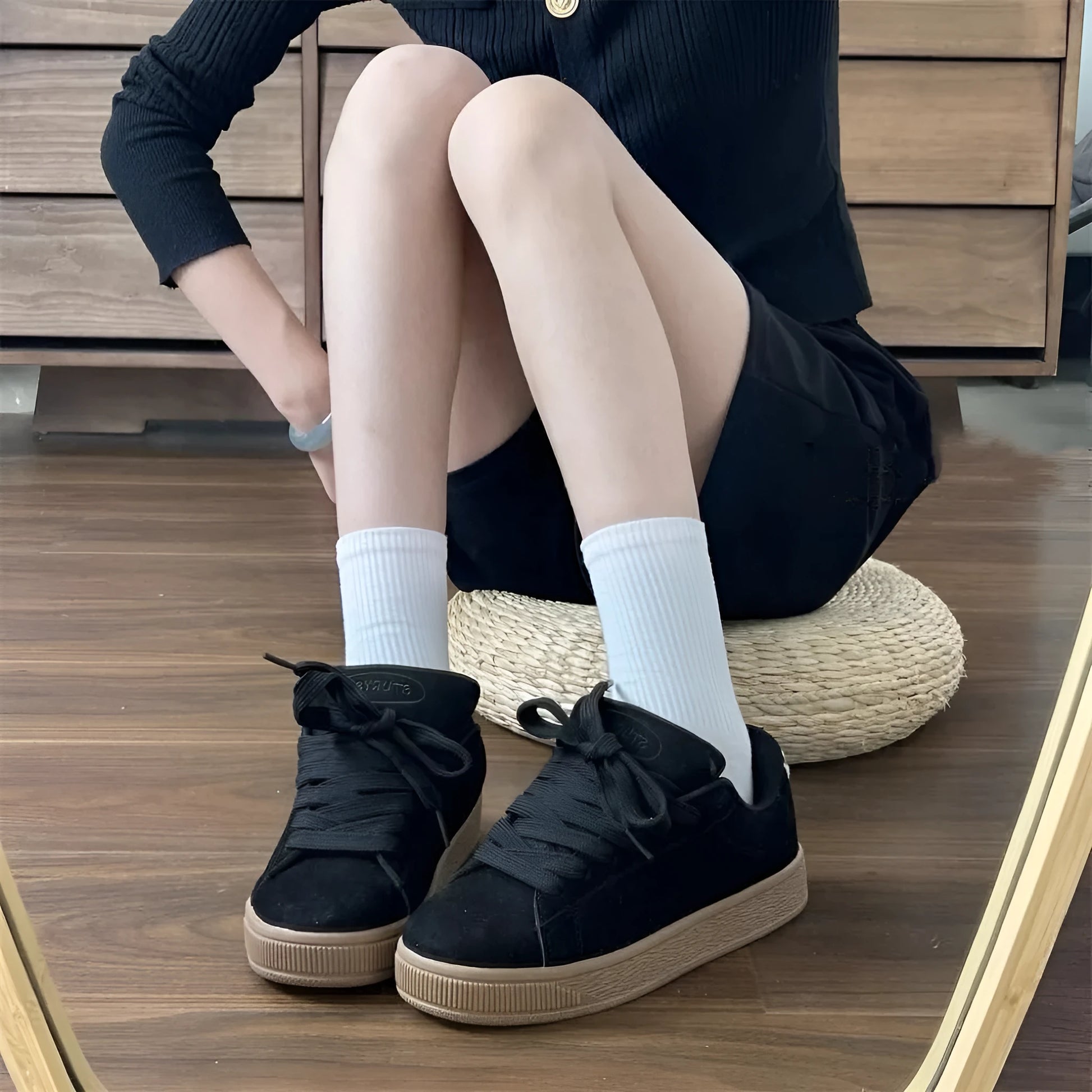 Black retro low-top sneakers with round toe, lace-up front, and a waterproof platform sole.