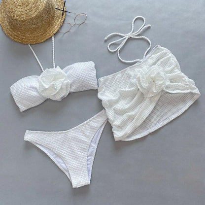 White three-piece women's bikini with 3D flower split design on a mannequin.