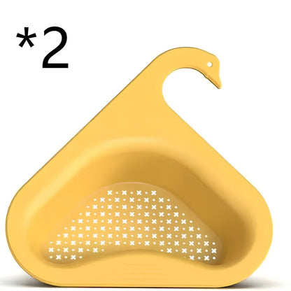 Yellow swan-shaped plastic kitchen drainer basket with drainage holes on kitchen counter