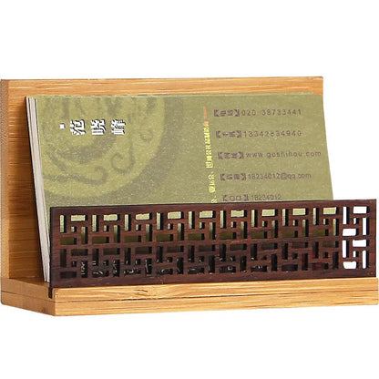 Geometric bamboo and black walnut wood business card holder on a desk.