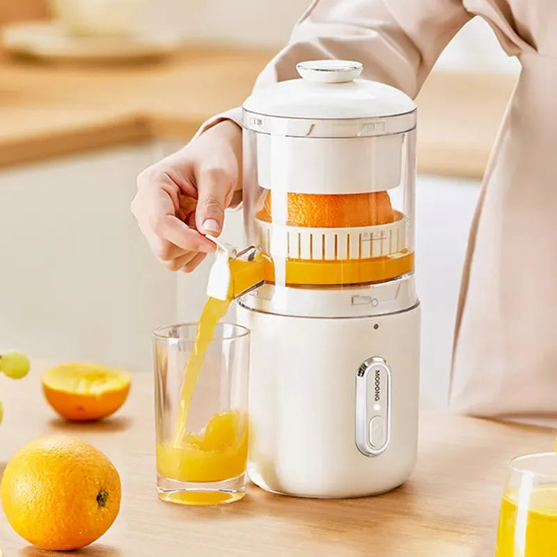 Fresh green portable electric juicer with USB charging cable and orange on a wooden table