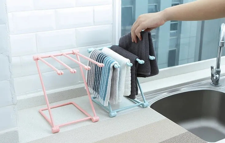Foldable plastic dishcloth shelf organiser in Nordic style mounted on a kitchen wall
