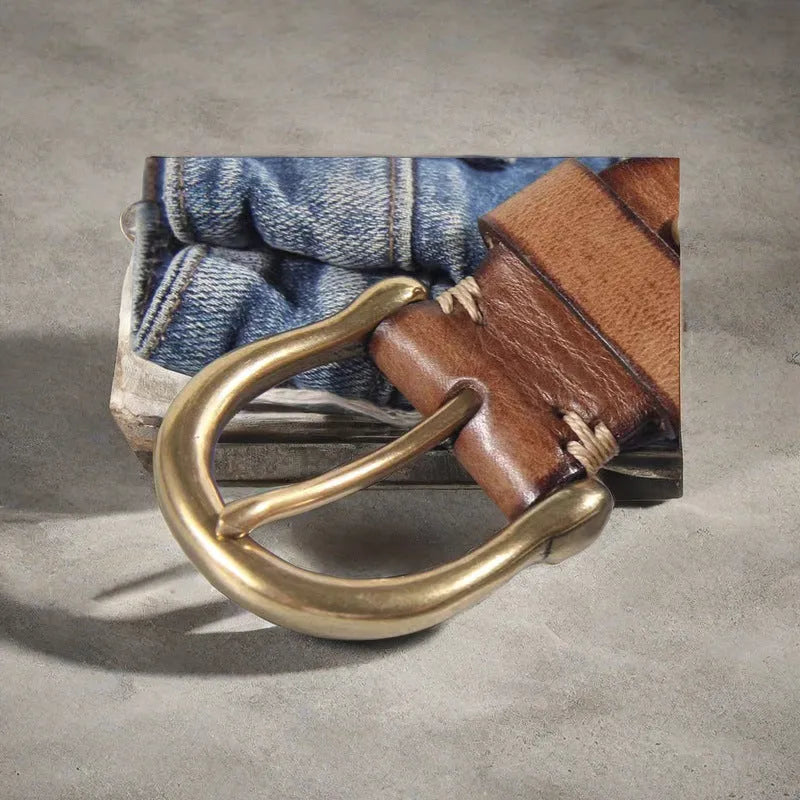 Men's black genuine cattlehide leather belt with a copper pin buckle on a jeans background.