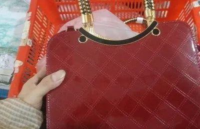 Lingge PU square shoulder bag for women with rhombic quilted design, zip opening, and hard handle.