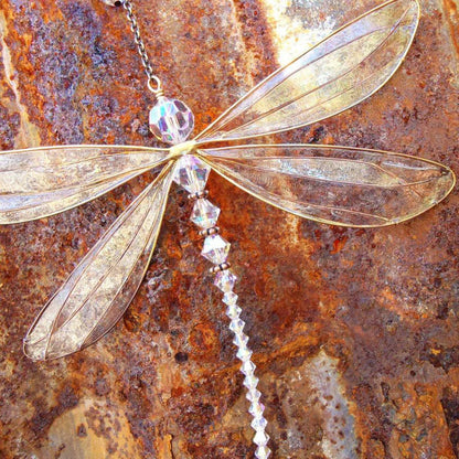 Radiant dragonfly crystal suncatcher with vibrant rainbow colors reflecting on walls and floors