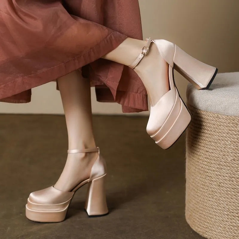 Women's white chunky heel platform pumps with a round toe and mid-calf cut.