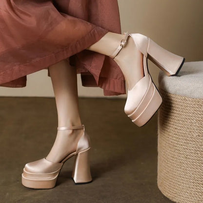Women's white chunky heel platform pumps with a round toe and mid-calf cut.