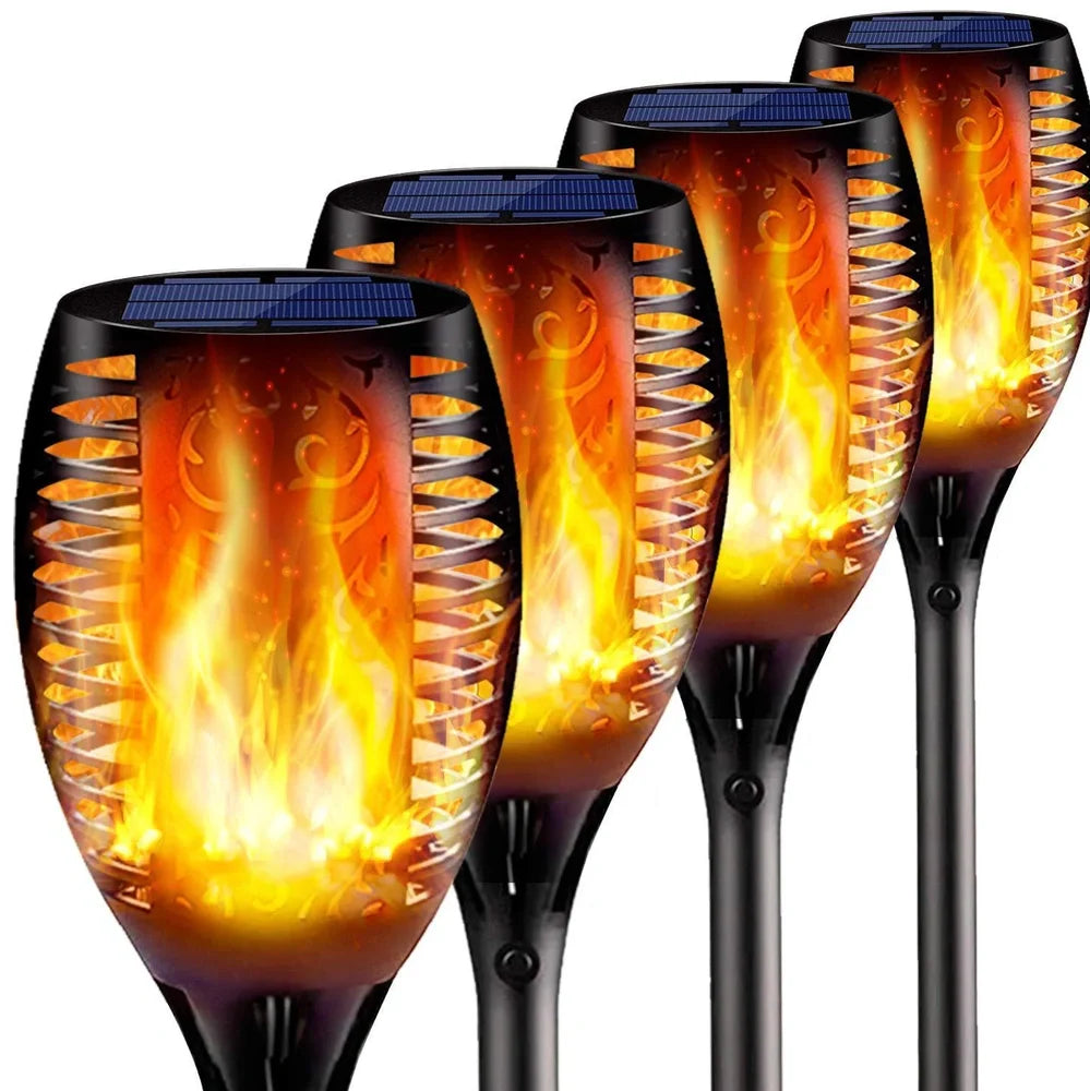 Solar garden LED light with flame flickering effect on stainless steel stake in outdoor setting