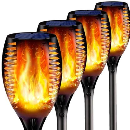Solar garden LED light with flame flickering effect on stainless steel stake in outdoor setting