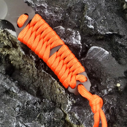 Outdoor survival knife with straight blade, rope-bound handle, and black ABS sheath on grey background