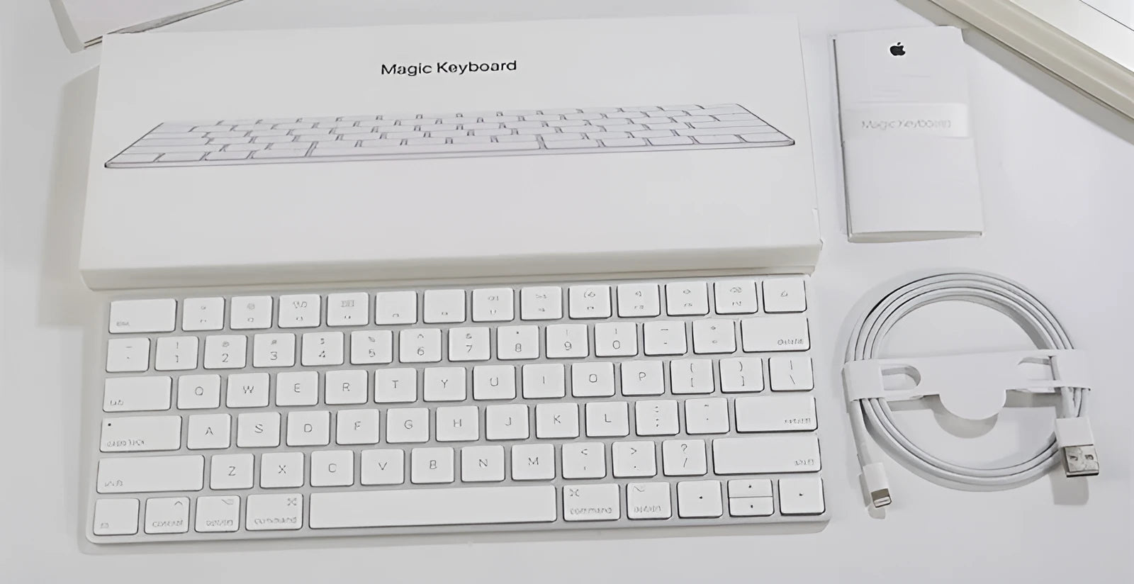 White Apple G6 ultra-thin metal Bluetooth wireless keyboard on a desk