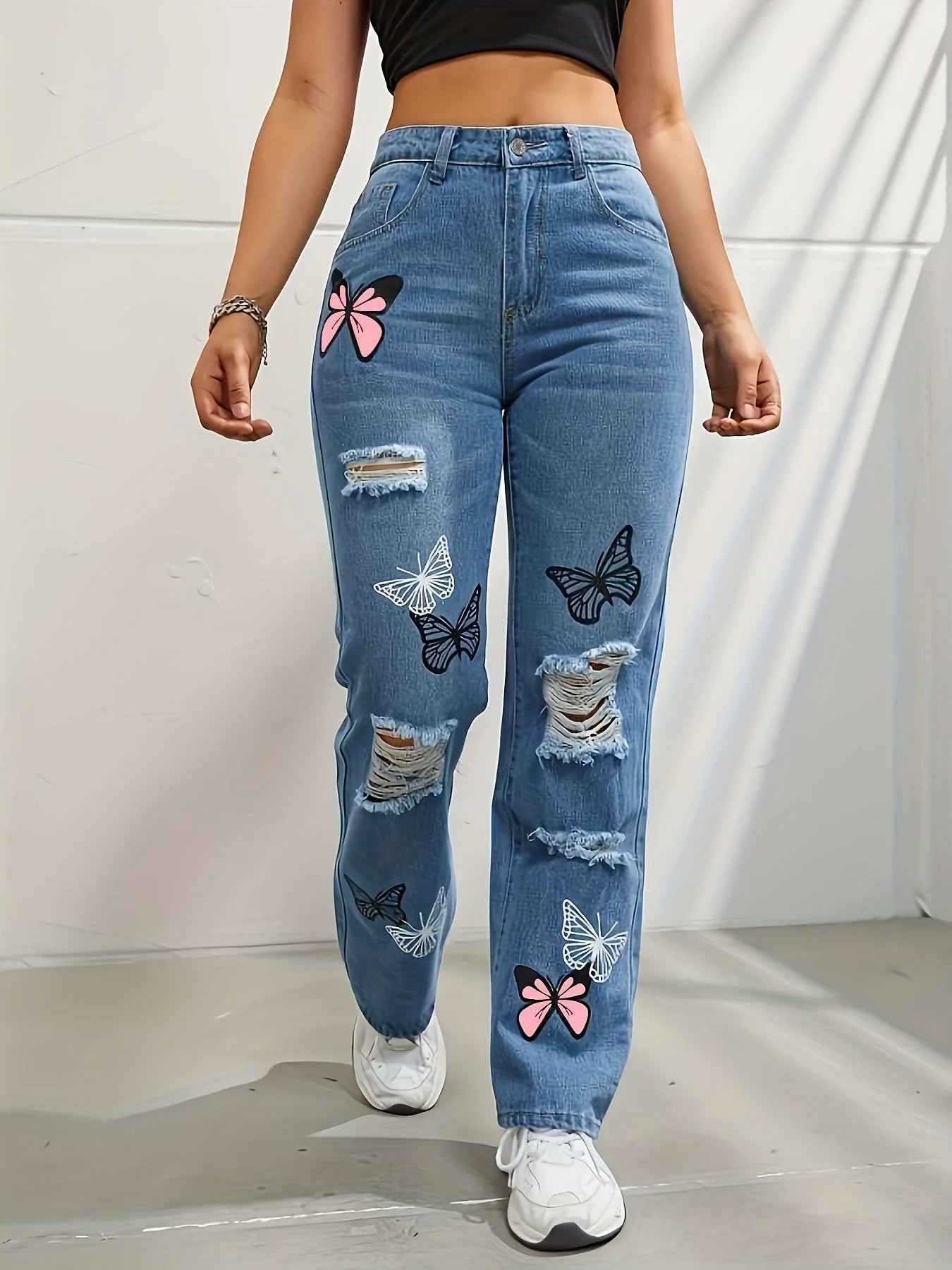 Women's high waisted straight leg jeans with butterfly print and distressed details