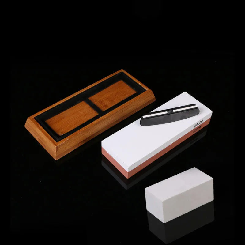 Green and white double-sided whetstone with bamboo base and sharpening accessories