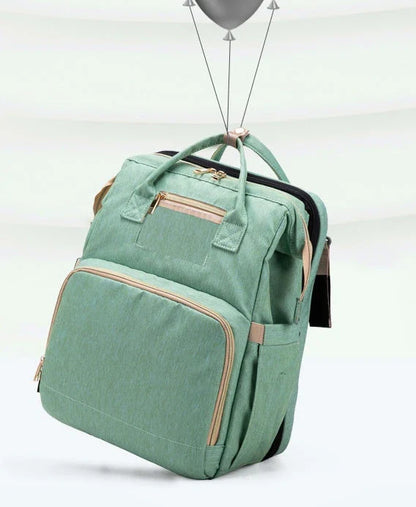 Versatile baby changing backpack with USB charging port and folding portable bed