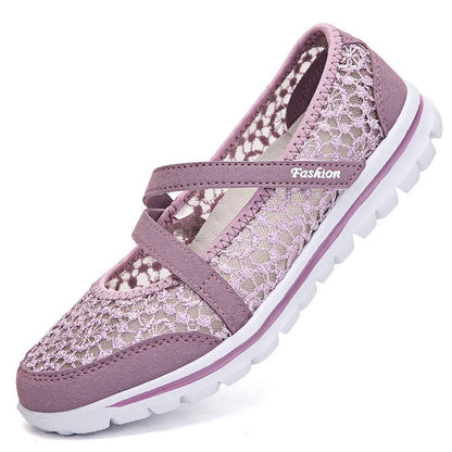 Women's beige mesh lace-up flat shoes with round toe and sewing line detail on a white background.