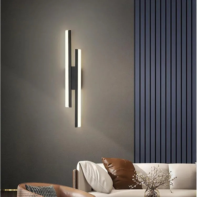 Scandinavian minimalist LED wall light with acrylic shade and adjustable arm in black or gold finish.