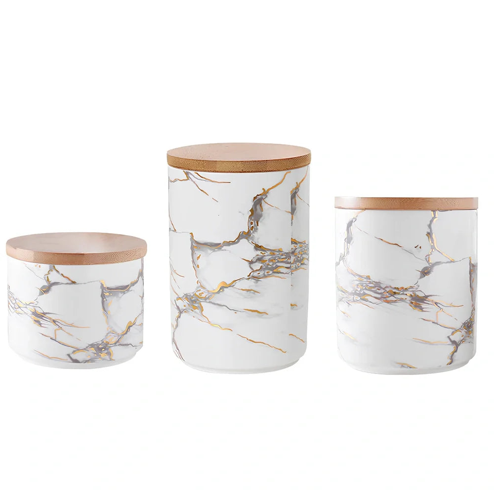 Three marbled ceramic storage jars with wooden lids showing large, medium, and small sizes
