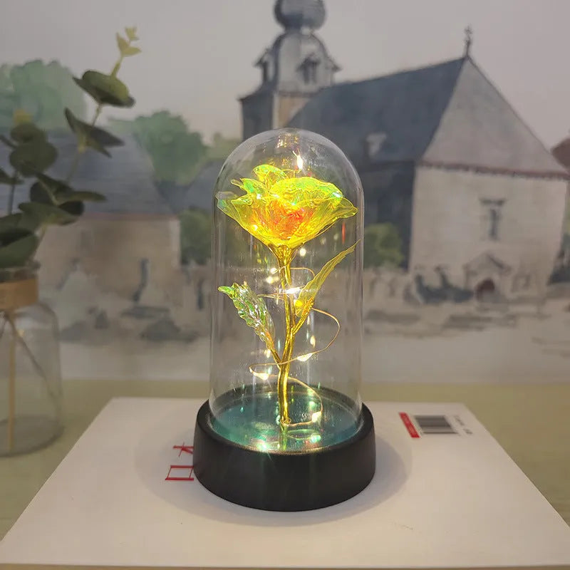 Glass cover small night lamp with plastic flowers, 15cm height, black base, showing colour light options