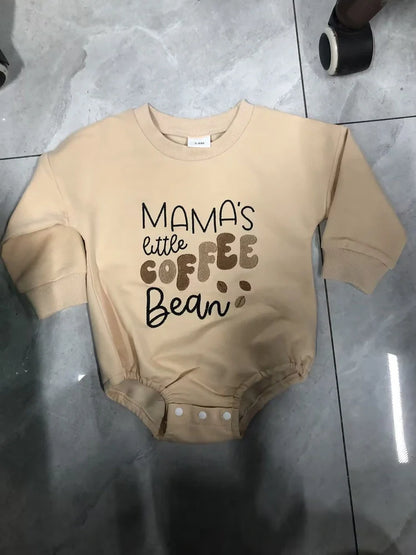 Apricot coloured infant jumpsuit with embroidered alphabet detailing and long sleeves