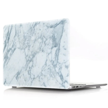Plastic MacBook protective case in a marble pattern colour, shown next to a compatible Apple laptop.