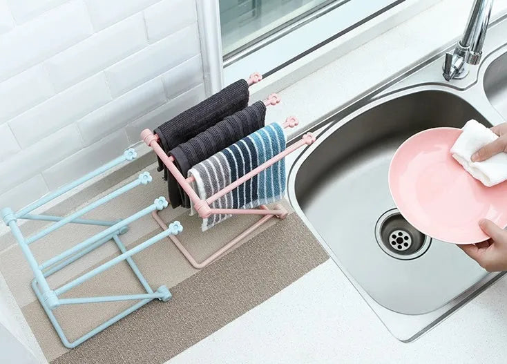 Foldable plastic dishcloth shelf organiser in Nordic style mounted on a kitchen wall