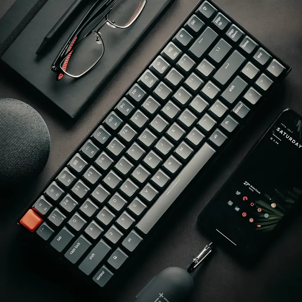 Grey 87-key mechanical keyboard with white backlight showing USB, Bluetooth and Type-C connectivity ports