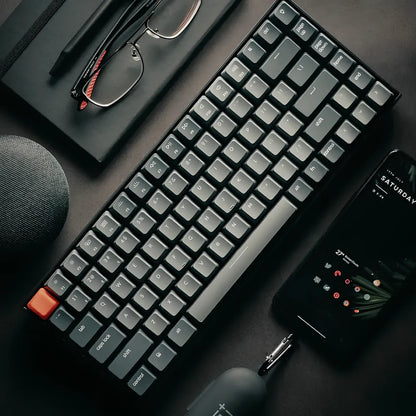 Grey 87-key mechanical keyboard with white backlight showing USB, Bluetooth and Type-C connectivity ports