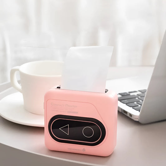 Compact Avocado Green mini Bluetooth thermal printer with mobile phone, thermal paper roll, and charging cable.