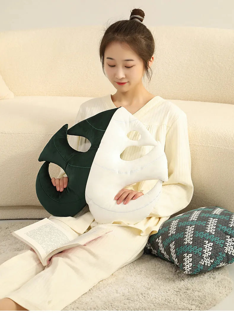 Green embroidered plant cushion with monstera leaf pattern on plush fabric