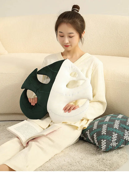 Green embroidered plant cushion with monstera leaf pattern on plush fabric