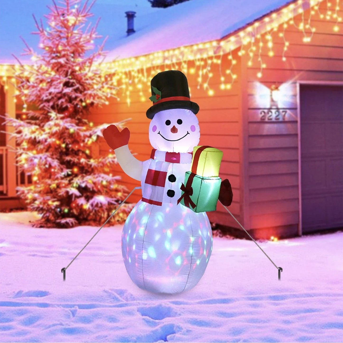 Glow-in-the-dark Christmas inflatable decorations featuring a Santa, snowman, and Christmas tree