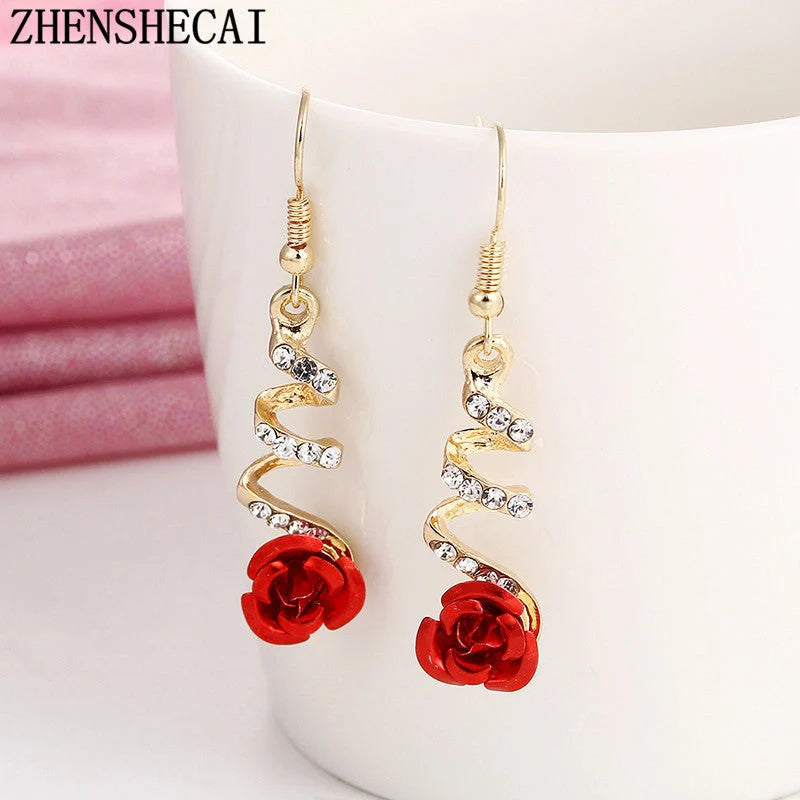 Ethnic red rose drop earrings with big rhinestones in rose gold spiral design