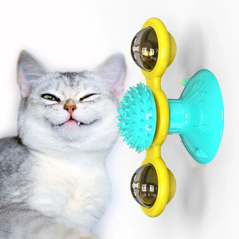 Cat playing with rotating windmill toy featuring suction base and luminous ball