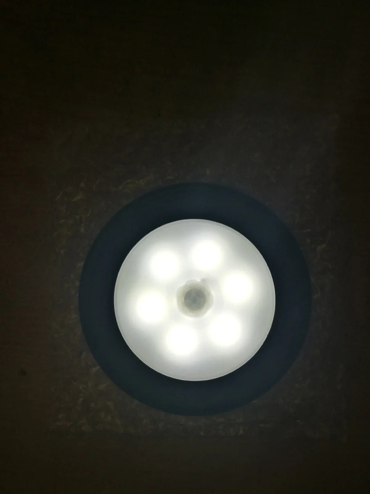 White motion-sensing LED cabinet lamp with magnetic back for wireless installation