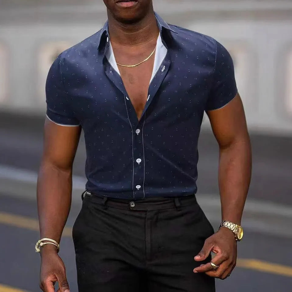 Man wearing a light blue short-sleeved floral print shirt with a casual cardigan style.