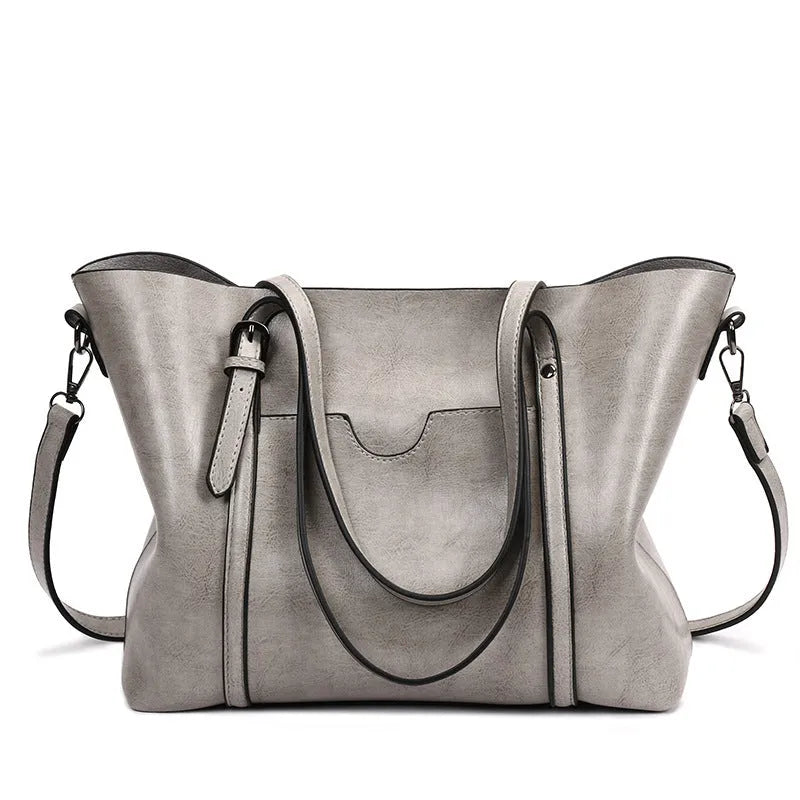 Retro messenger bag showing 31cm length, A4 magazine capacity, available in eight colours including wine red and light blue