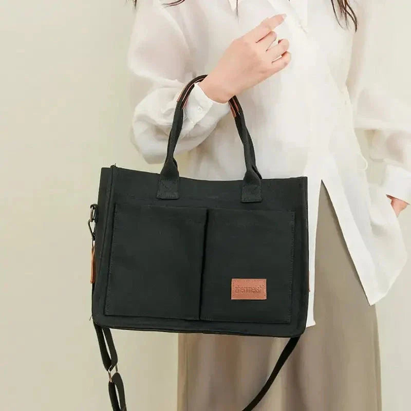 Premium canvas tote bag in multiple colors with adjustable shoulder strap and organizational pockets