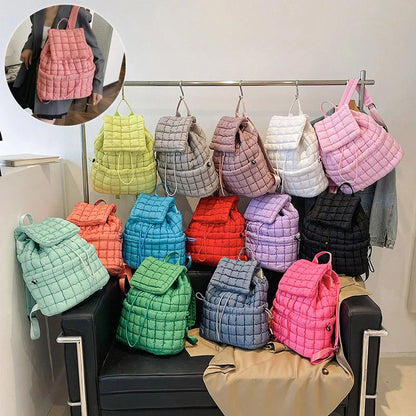 Soft, quilted puffer backpack in a variety of colors, perfect for autumn and winter wear