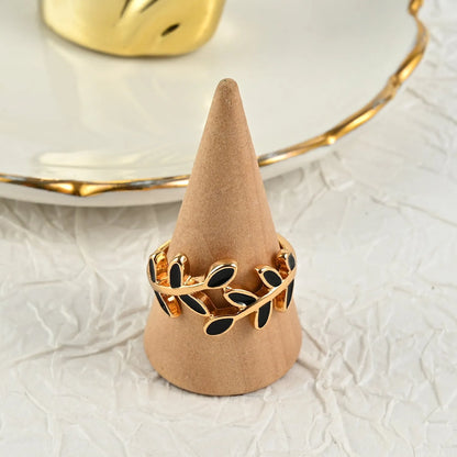 Gold electroplated geometric ring with leaf motif and acrylic accents for women's index finger