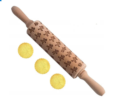 Wooden rolling pin with engraved Christmas patterns including reindeer and snowflakes on a 45cm long barrel.
