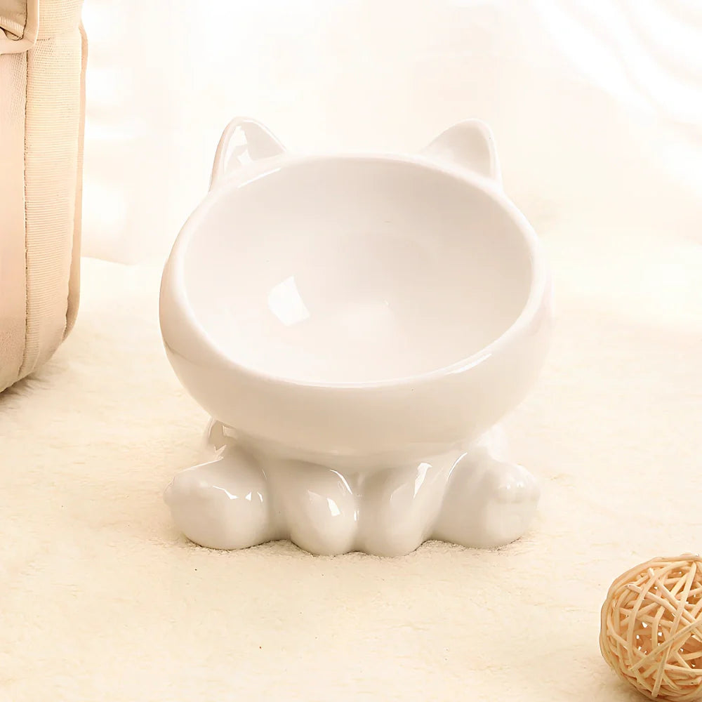 Black and white ceramic cat bowl with oblique mouth and neck guard for reduced whisker fatigue