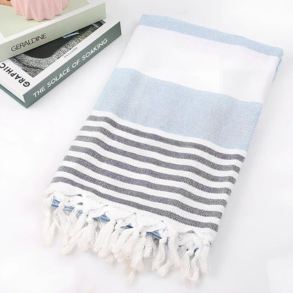 Striped Turkish beach towel showing blue and white pattern, measuring 100cm by 180cm