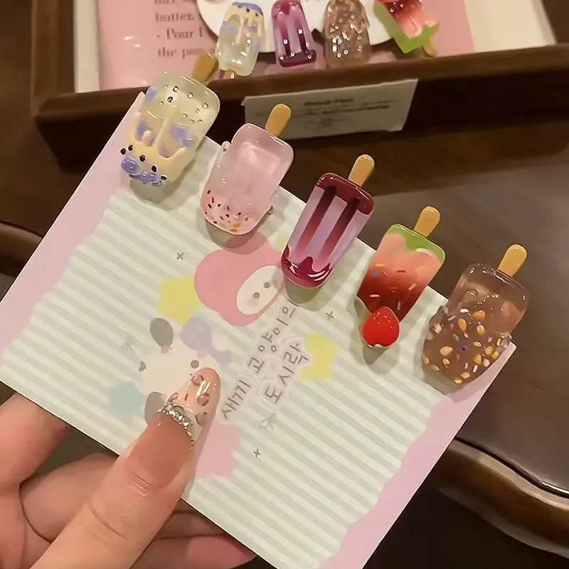 A resin hair barrette with a cartoon ice cream charm on a side-clip, shown in a pink colour variant.