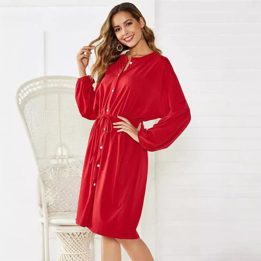 A-line mid-length dress with elastic waist, cinched belt, and long sleeves in solid black or red colour