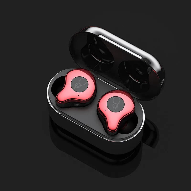 Coffee-coloured true wireless Bluetooth earbuds sitting in an open charging case on a wooden table.