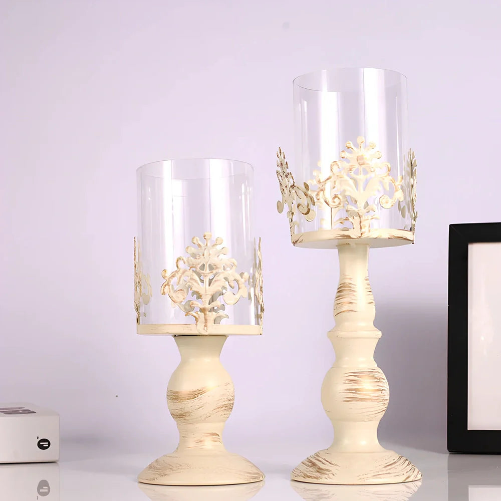 Iron candle holder with birdcage design measuring 37cm height and carved glass version at 33cm