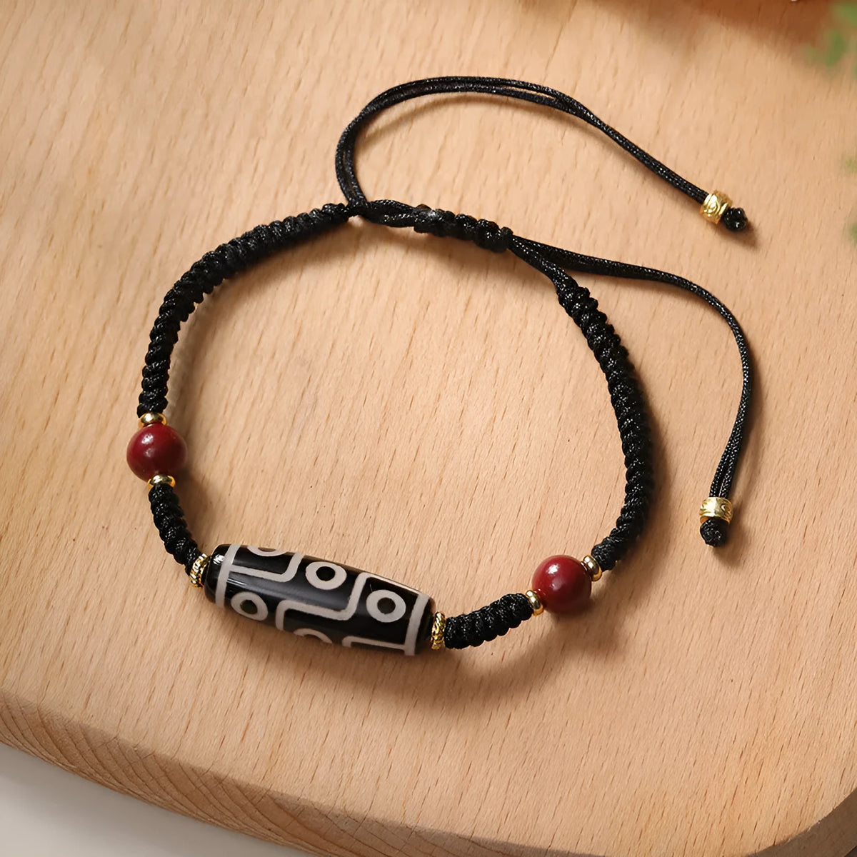 Men's adjustable agate dzi bead bracelet with traditional symbols on a shrinkable band.