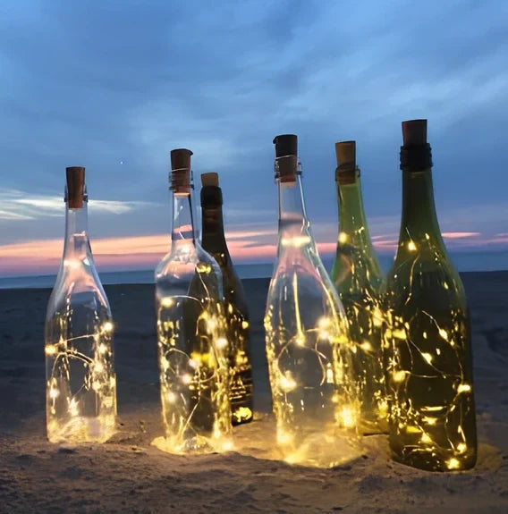 Copper wire LED string lights wrapped around wine bottle with 20 white LEDs illuminated