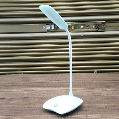 White foldable LED desk lamp with touch button and USB charging port on a desk