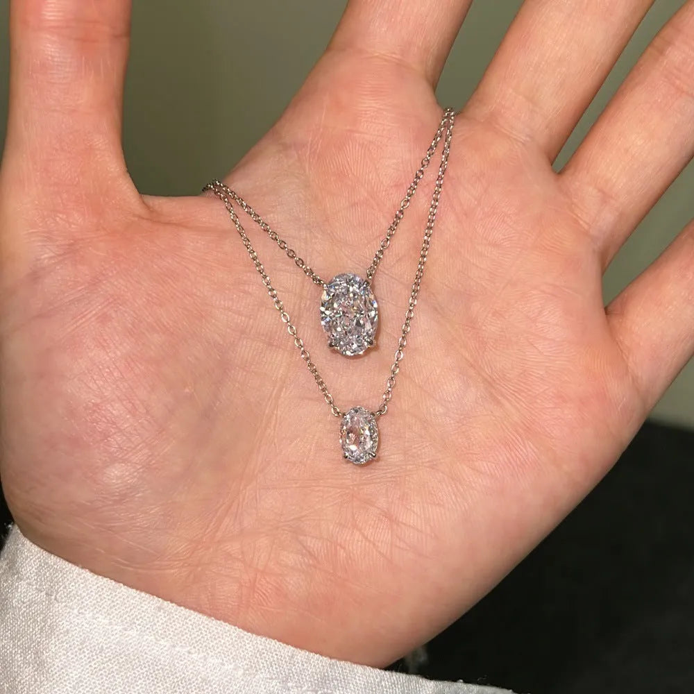 Close-up of a geometric oval ice flower pendant necklace in sterling silver with a choice of platinum or gold tone finish.